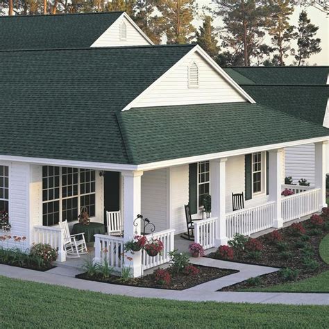 green brick house with white metal roof|house with green roof colors.